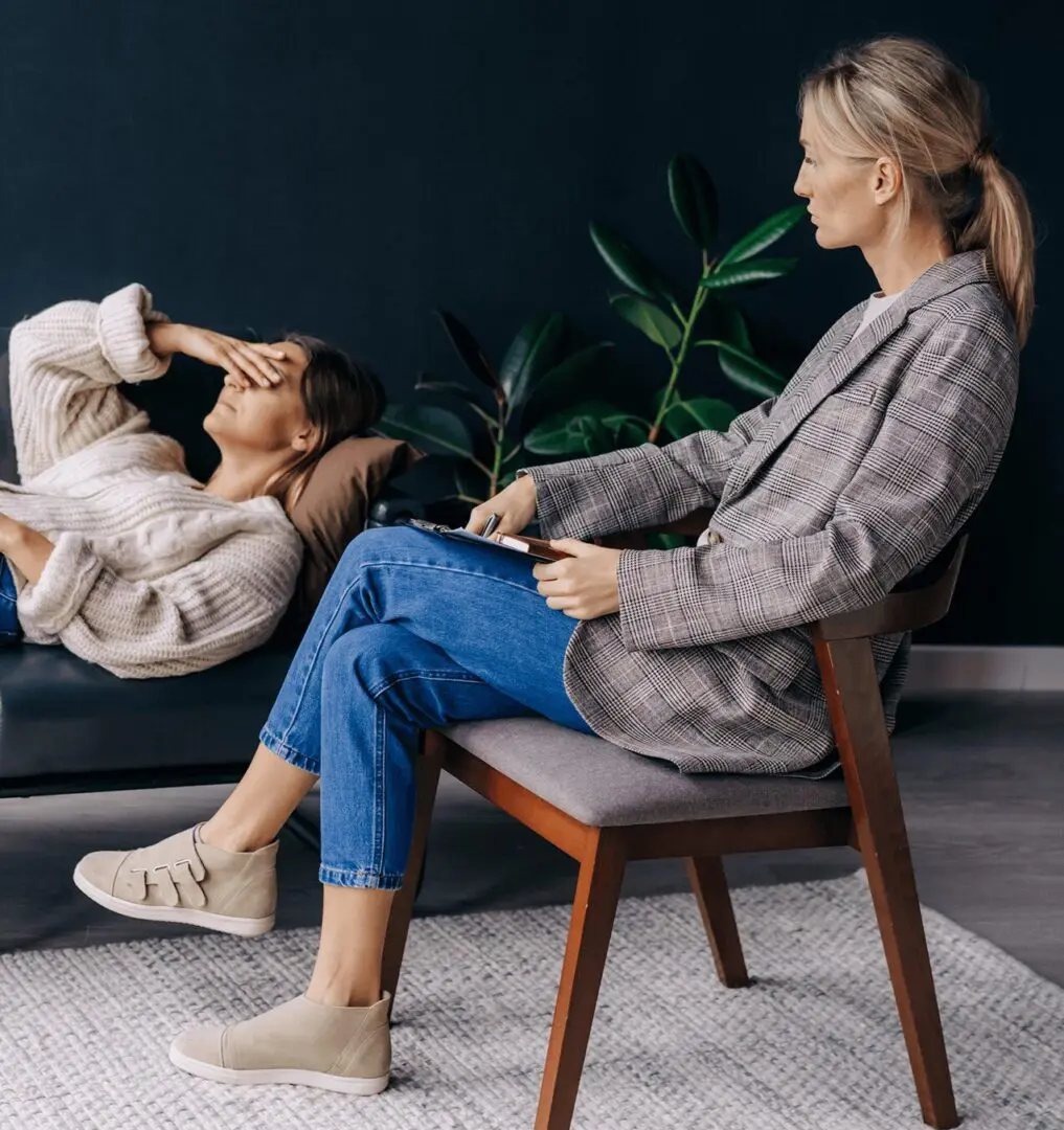 A woman sitting on the chair next to a man.