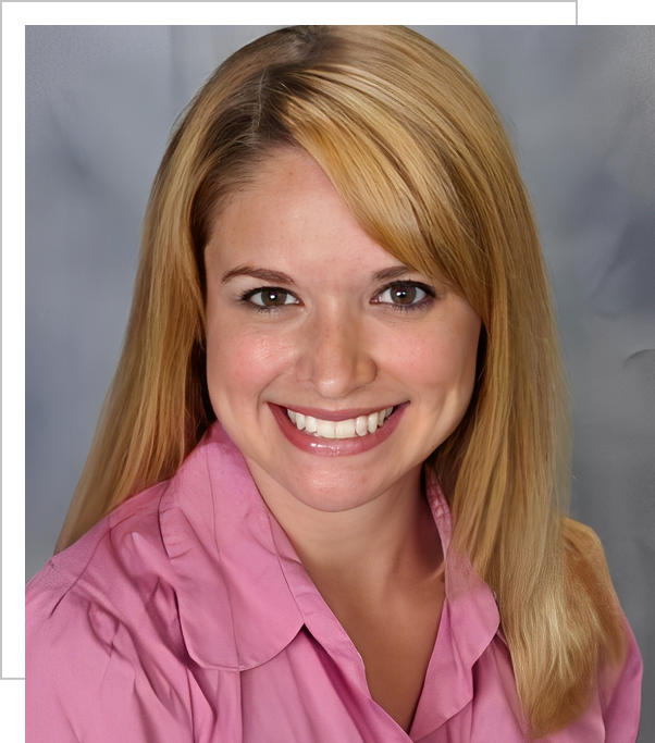 A woman in pink shirt smiling for the camera.