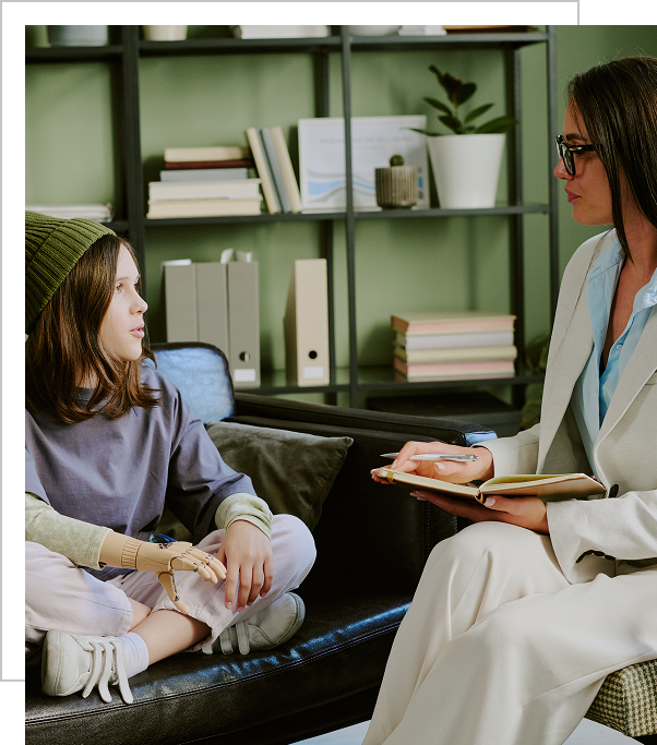 A woman sitting on the couch with a young girl.